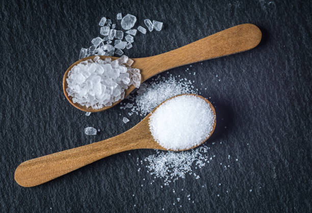 istock Different types of salt. Top view on two wooden spoons 964129344