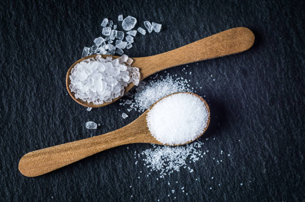 istock Different types of salt. Top view on two wooden spoons 964129498