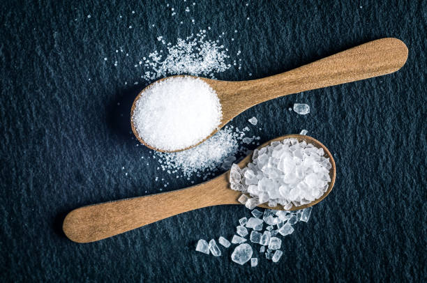 istock Different types of salt. Top view on two wooden spoons 964129710
