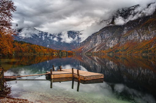 Beautiful lake in Julian Alps with empty pier during an autumn day.