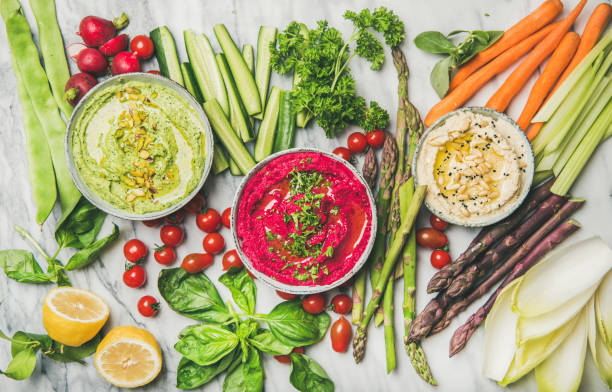 Healthy summer vegan snack plate with hummus and vegetables