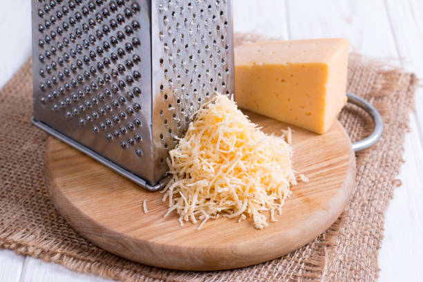 istock Grated cheese on a wooden cutting board 964135816
