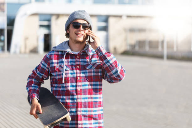 istock Man with Skateboard and Phone 964136442