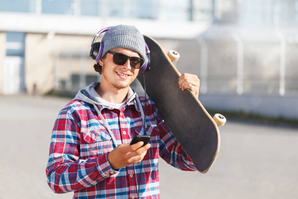 istock Man with Skateboard and Phone 964136718