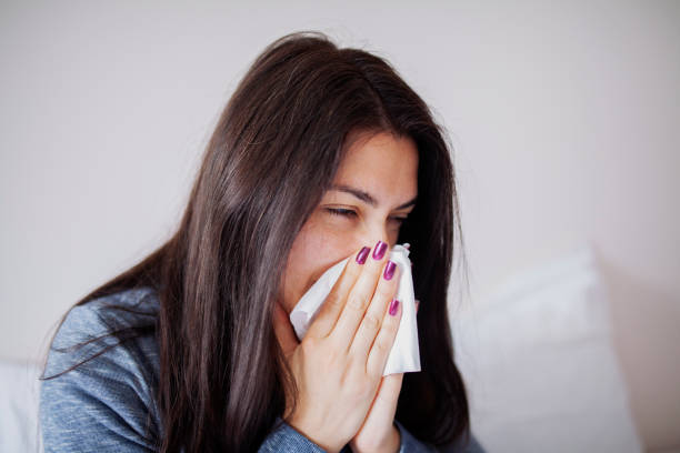 istock Sneezing woman 964139244