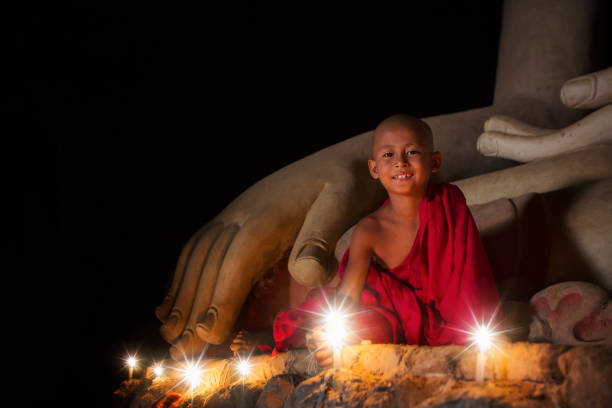 A boy in buddhism set fire with candle in bagan, Myanmar