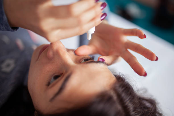 istock Young woman putting eye drops 964143834