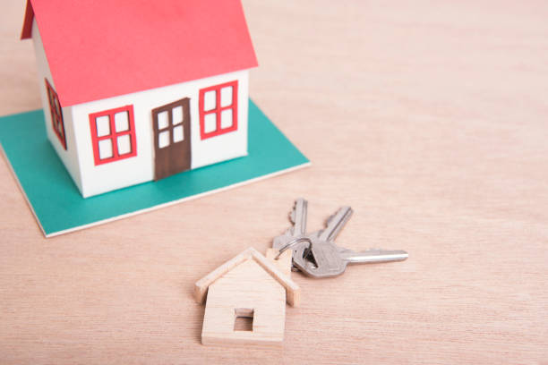 istock Key home and model house on wood table background. 964147488