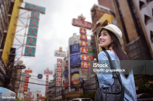 Young Asian Woman Traveler With A Backpack On Her Shoulder And Travel Hat Walking On Footpath Over China Town Bangkok Thailand Travel Holiday Relaxation Concept Stock Photo - Download Image Now