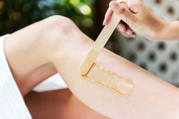 Woman getting legs waxed at a spa Woman getting legs waxed at a spa hair removal photos stock pictures, royalty-free photos & images