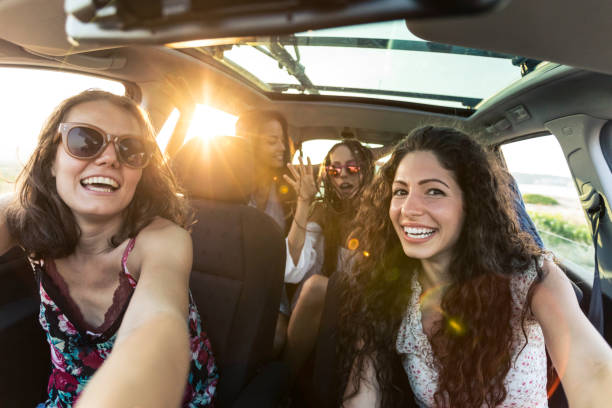 istock Carefree girlfriends enjoying car trip 964151530