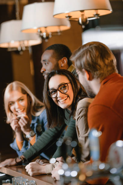 istock cheerful young attractive friends at bar 964151894