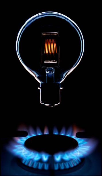 GLOWING LIGHT BULB FLOATING OVER GAS COOKER FLAME