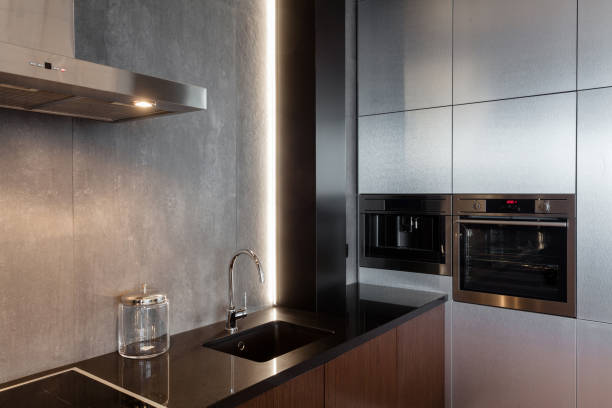 istock New modern kitchen with built in extractor hood, oven and chrome water tap. LED worktop illumination 964155126
