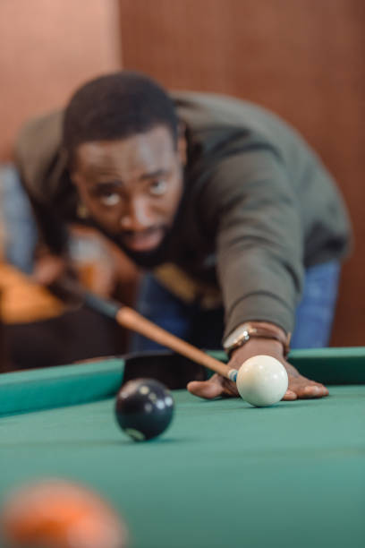 istock african american man playing in pool at bar 964158368