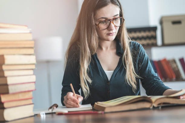 istock Young girl reading book on the table 964158374
