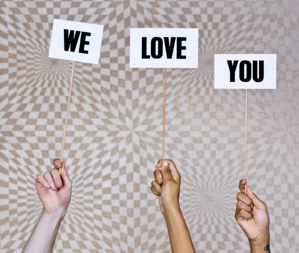 istock Three hands hold up signs reading 