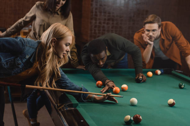 istock young attractive multiethnic friends playing in pool at bar 964162888