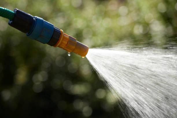 istock WATER SPRAYING FROM GARDEN HOSE PIPE 964163330