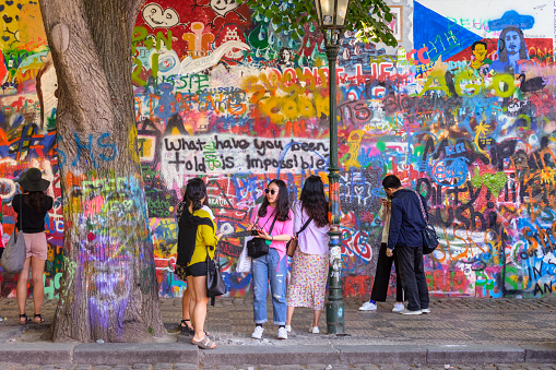 Prague, Czech Republic - May 12, 2018:  View of the Lennon Wall in Prague, Czech Republic. Since the 1980s this wall has been filled with John Lennon-inspired graffiti.