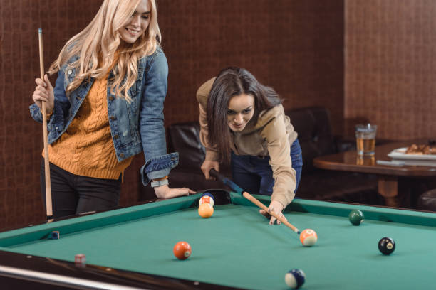 istock two young girls playing in pool at bar 964163510