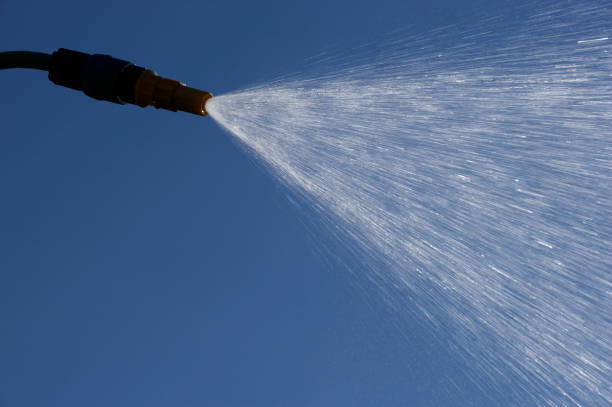 istock WATER SPRAYING FROM GARDEN HOSE PIPE 964163520