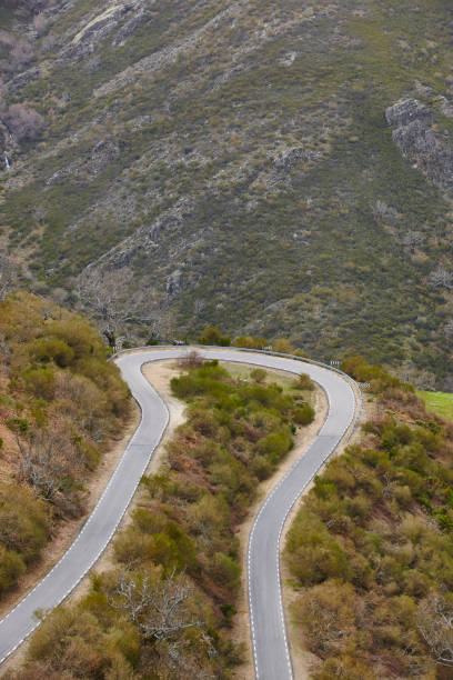 istock Empty curved asphalt mountain road. Rural scenic travel 964163632