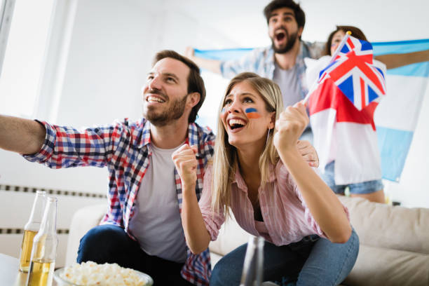 istock Group of multi-ethnic people celebrating football game 964164506