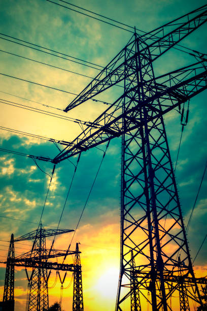 Electricity industry high voltage towers in the sunset