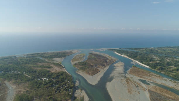 istock River flowing into the sea 964167356
