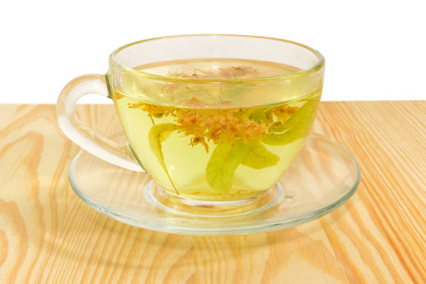 istock Linden flower tea in transparent glass cup closeup 964168418