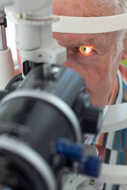 istock Close-Up Of Man Looking Through Optometrist Phoropter 964168658