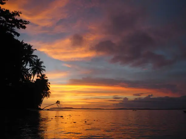 Stunning sunset with warming tropical vibes from a beach in a Mentawai island in Indonesia.