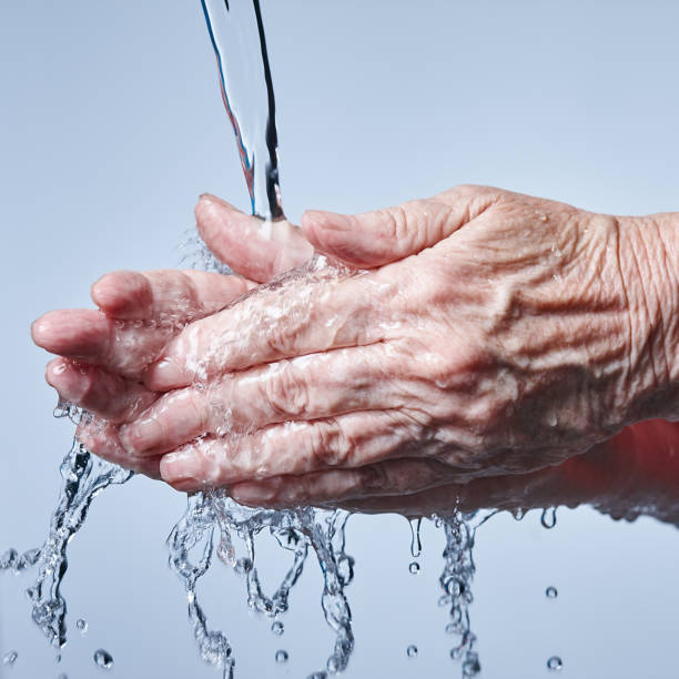 istock Hand washing: Senior woman's hands being washed under running water 964172778