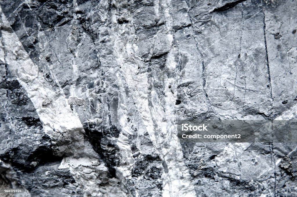 Granite stone texture grunge scratched wall background rough. Abstract construction concrete stone wall. Mountain rock or volcano stone. Cool and chic adventure wallpaper. Black and white color. Close up. Abstract Stock Photo