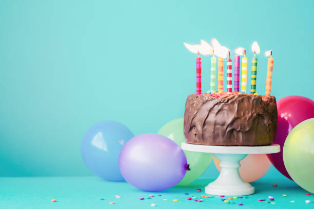 istock Chocolate birthday cake with colorful candles 964177120