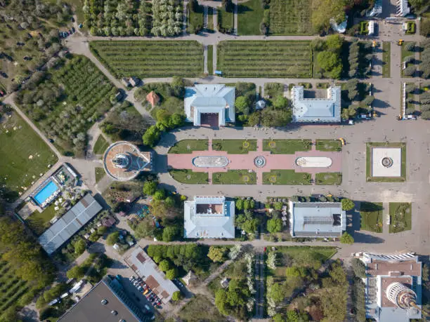 Aerial view city of Kiev national exhibition center with pavilions, a park and a swimming pool in the spring on a sunny day. Photo from the drone