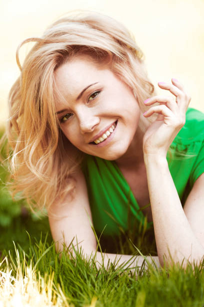 istock woman lying on green grass 964177762
