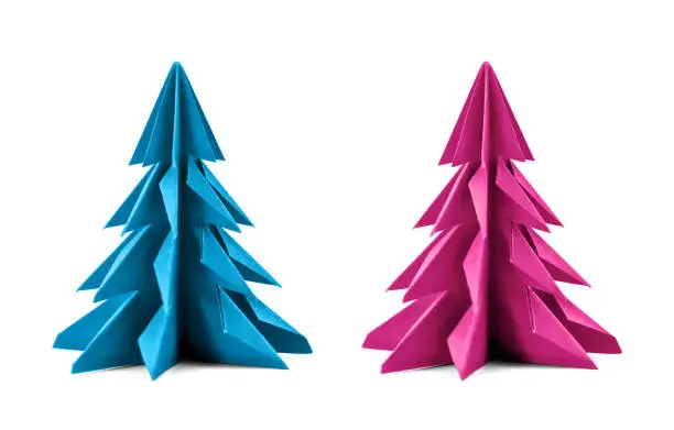 Origami Christmas tree paper isolated on white background. For decoration, Merry Christmas or Happy New Year postcard. Blue and pink color. Front view. Close up.