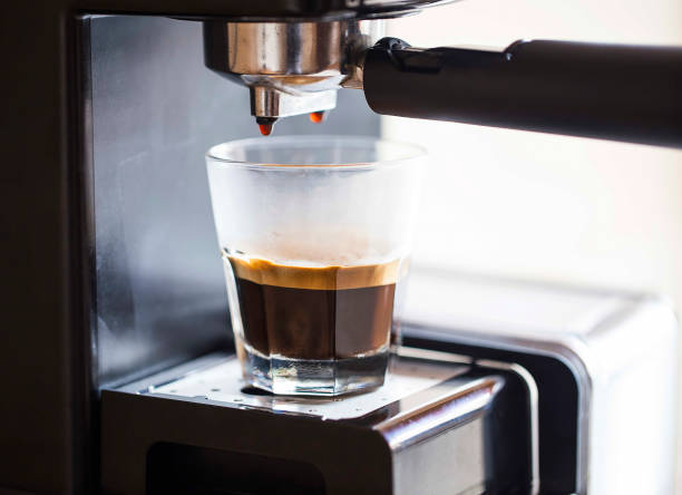 istock Espresso coffee pouring from coffee machine, espresso coffee drink 964180626