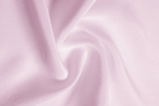 istock Texture background pattern. Pink silk fabric. Closeup of a rippled pink silk fabric. Advertising space. Smooth elegant pink silk can be used as a wedding background. 964187134