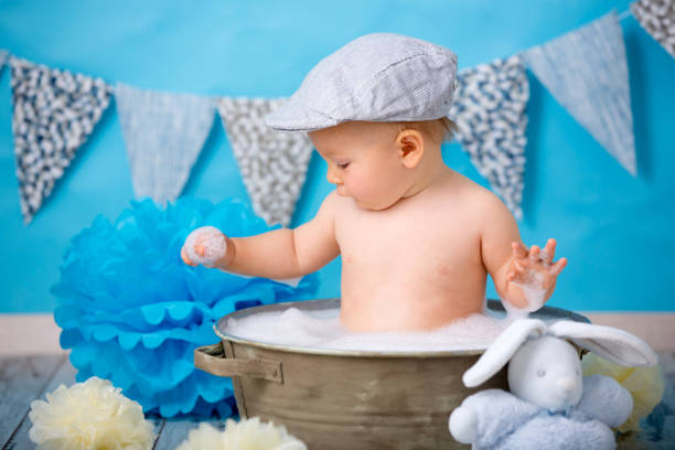 istock Cute baby boy, having bath after smash cake, isolated shot 964190650