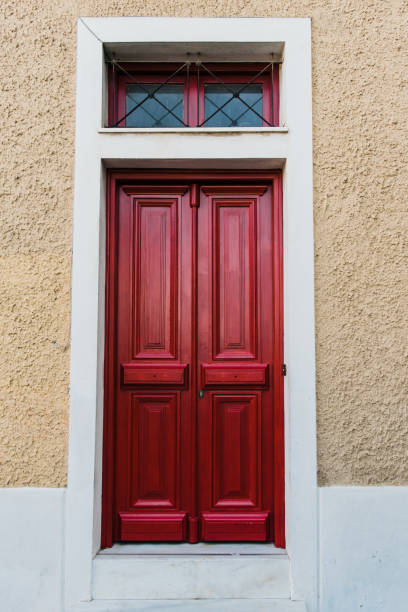 Vintage red wooden door entrence. Vintage red wooden paneled front door. Athens. Greece. entrence stock pictures, royalty-free photos & images