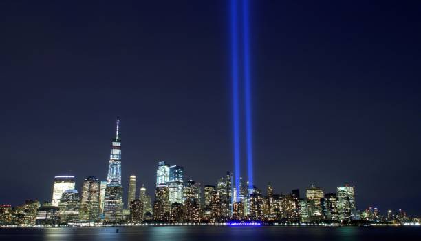 Tribute in Light - Lower Manhattan Skyline from Jersey City 2017 Jersey City, USA - September 11, 2017: Night view from Liberty State Park. Tribute in Light represents the Twin Towers in remembrance of the September 11 attacks. It was sixteenth anniversary of 9/11. Photo with corrected lens distortion. 2017 photos stock pictures, royalty-free photos & images