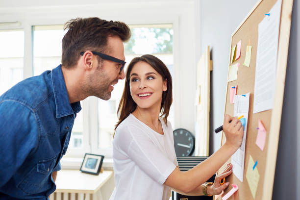 istock Creative couple working at office planning new business ideas 964192012