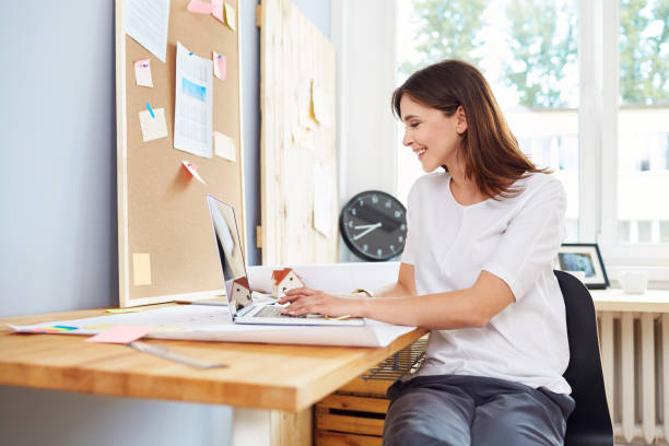 istock Successful young woman, architect working on laptop at office 964194832