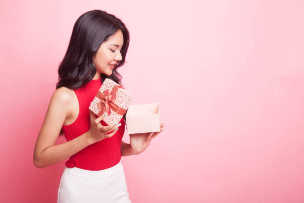 istock Young Asian woman open a gift box. 964196812