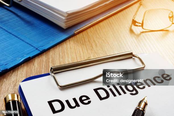 Document With Title Due Diligence On A Desk Stock Photo - Download Image Now - Efficiency, Deadline, Business