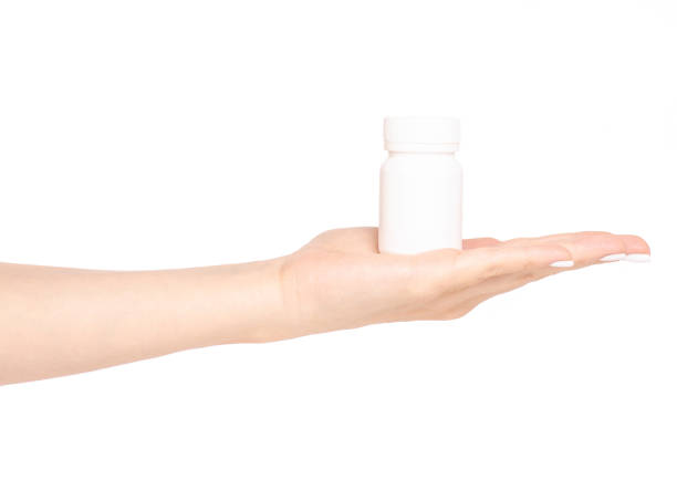 istock White jar of pills in hand 964201368
