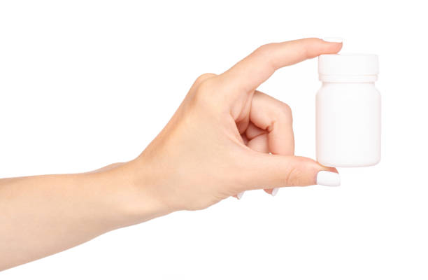 istock White jar of pills in hand 964201444